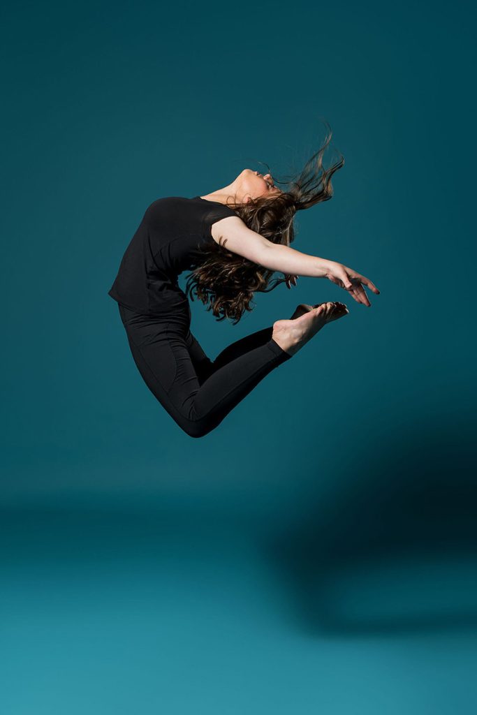 girl leaping into air in dance pose