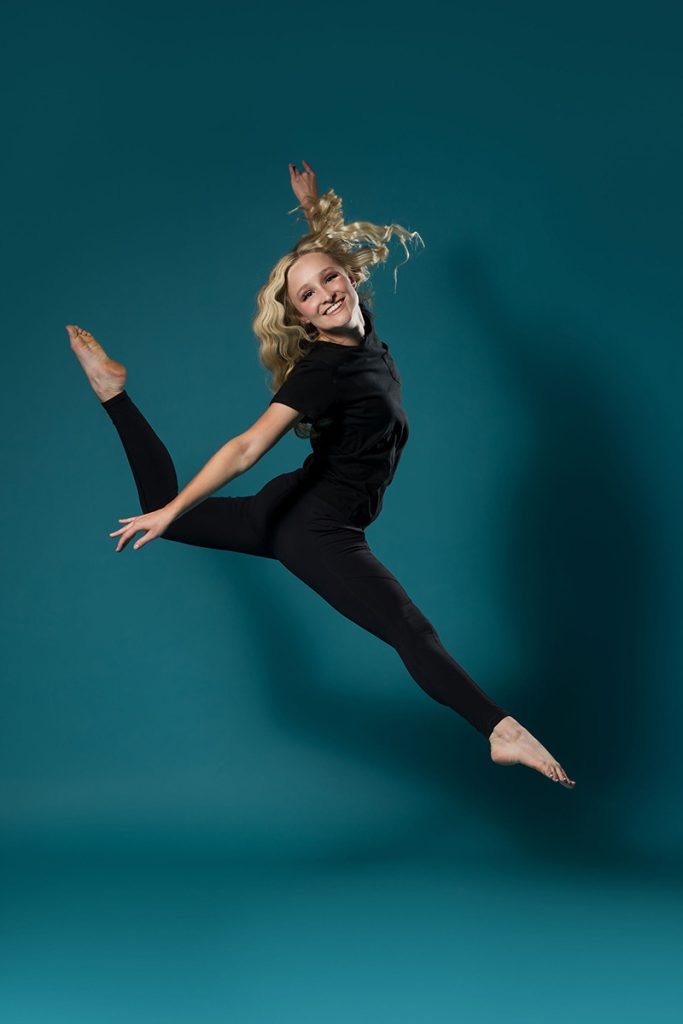 girl jumping into the air in dance pose